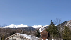 春の乗鞍高原に広がる残雪の山々と高原風景
